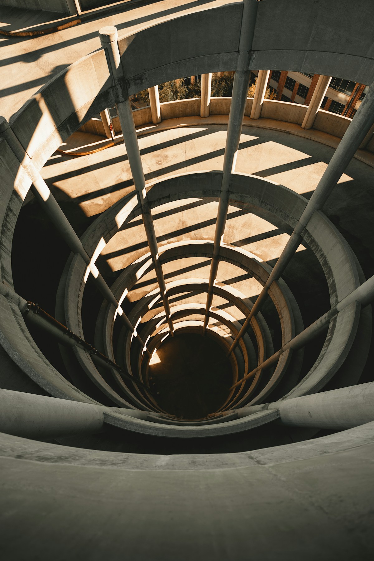 Sweeping architectural lines in a sunlit spiral stairwell